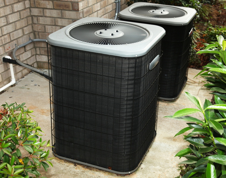 two-outdoor-ac-units-with-power-and-refrigerant-line-showing
